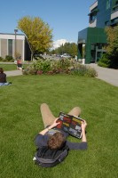 A student lounges in the Cuddy Quad on UAA's campus.