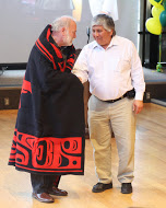 Steve Langdon receives a gift from Sealaska, presented by Patrick Anderson. Photo by Kathleen Behnke.