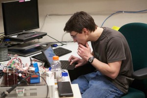 Nathaniel Cox researches data in the lab at UAA. (Photo by Philip Hall/UAA)
