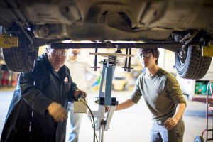 Mechanic and student tackle engine removal