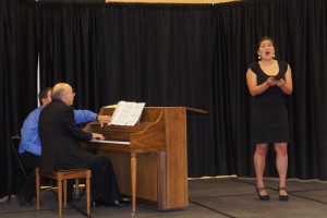 Performing in Unalakleet with UAA professor of piano Tim Smith. Local music teacher Timothy Wolcott turns pages whlle Kira sings opera selections. Smith and Eckenweiler timed the concert to perform for 300 Bering Strait School District teachers there for an inservice in August.