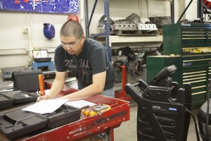 Chris Converse works on a test during his GM Automotive Service Educational Program class at UAA. (Photo by Philip Hall/UAA)