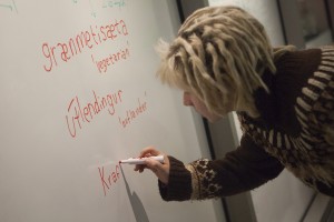 Alyx Shroy, president of Nordik Language Klub, adds a few Icelandic vocabulary words to the whiteboards in ConocoPhillips Integrated Science Building. (Photo by Philip Hall/University of Alaska Anchorage)