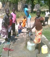 Children in Old Fangak, South Sudan, fill containers with clean water from one of the wells Alaska Sudan Medical Project volunteers drilled. (Photo courtesy of ASMP)