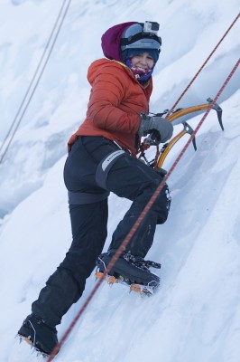 Phyical education major Tara McMurray looks back at her belay team midway up the wall (Photo by Philip Hall/University of Alaska Anchorage).