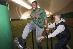 Rafael assists David during a recent conditioning day at the Dome (Photo by Philip Hall/University of Alaska Anchorage).