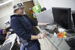 Kyle Fetters uses an ultrasonic testing tool during an NDT class. (Photo by Philip Hall/UAA)