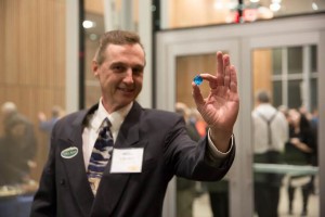 David Johnson, a Mat-Su College alumnus, holds the Blue Marble that signifies the theater design's environmentally significant features. As a student, Johnson founded the Mat-Su Carbon Crew, an environmental activist organization. (Photo by Heather Dunn, courtesy of Mat-Su College)