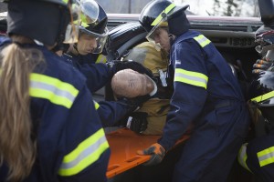 EMS students rescue a victim after fire science students stabilized the vehicle (Photo by Philip Hall/University of Alaska Anchorage). 