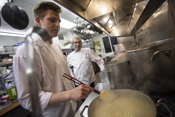 RJ Kruckenberg, a current UAA culinary student, was recently promoted to saucier at the Crow's Next. He spends two afternoons a week working one-on-one with Chef de Cuisine Reuben Gerber (Photo by Ted Kincaid / University of Alaska Anchorage).