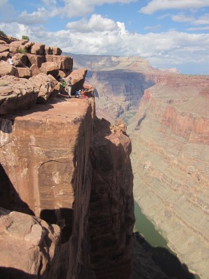 Life on the edge. Brave students perch atop the cliff at Toroweap Overlook at the Grand Canyon (click to enlarge) (Photo courtesy of Terry Naumann).
