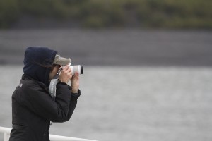 Geology senior Alex Busk shoots a photo on Portage Lake for her weekly report (Photo by Philip Hall / University of Alaska Anchorage). 