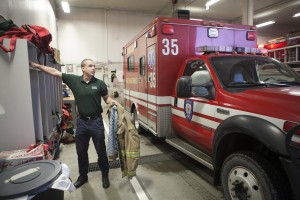 Forrest reacts to an early-morning emergency call at the fire house (Photo by Philip Hall / University of Alaska Anchorage).