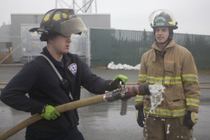 Zak and Forrest train with the fire hose outside the Chugiak Volunteer Fire Department (Photo by Philip Hall / University of Alaska Anchorage).