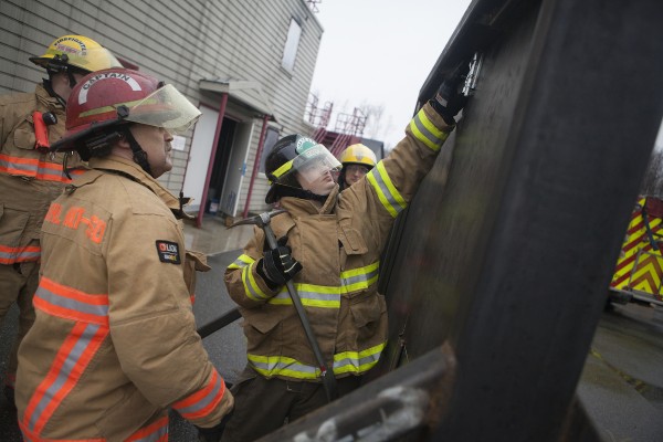 Timothy Robbins attempts to bust down a steel door in a new rescue training prop at the Central Mat-Su Fire Department (Photo by Philip Hall / University of Alaska Anchorage).