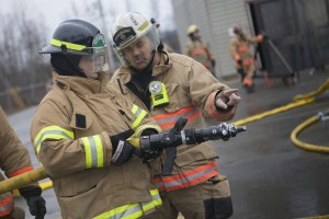 Tim gets some pointers from Deputy chief Keenan at the Central Mat-Su Fire Department (Photo by Philip Hall / University of Alaska Anchorage).