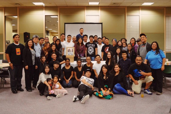 Jessica (front row, in dress), Dennis (far right, in apron) and members of UAA's Fil Am club and Alaskero Partnership Organizers pose for a photo after cooking a meal for 100 guests during Filipino American History Month (Photo courtesy of Dennis Perez).