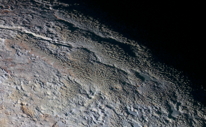 The Tartarus Dorsa Mountains rise up along Pluto. Credit: NASA/JHUAPL/SWRI