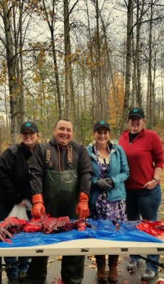 Amy Bishop in red sweater at right, after participating in a recent biosampling demonstration at the Alaska Native Heritage Center. (Photo provided by Amy Bishop/UAA)