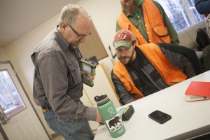 John Bean, left, helps Gerhard Hahn set up a GNSS rover unit in the geomatics classroom (Photo by Philip Hall / University of Alaska Anchorage).