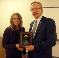 Gail Ealy accepts the Employee of the Quarter plaque from Vice Chancellor for Administrative Services Bill Spindle.