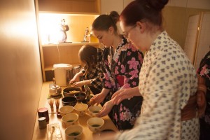 Behind-the-scenes students prepared extra tea to serve the large crowd at the "end of the year" tea ceremony (Photo by Philip Hall / University of Alaska Anchorage).