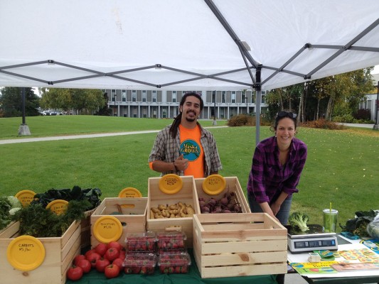 Devin Johnson and Kyla Byers sell produce on the UAA campus last year. Now, they sell it Thursday afternoons, 1-4 p.m., in the Social Science Building. Byers' company, Arctic Harvest Deliveries, provides produce grown by farmers in the Matanuska Valley. (Photo courtesy of Devin Johnson)