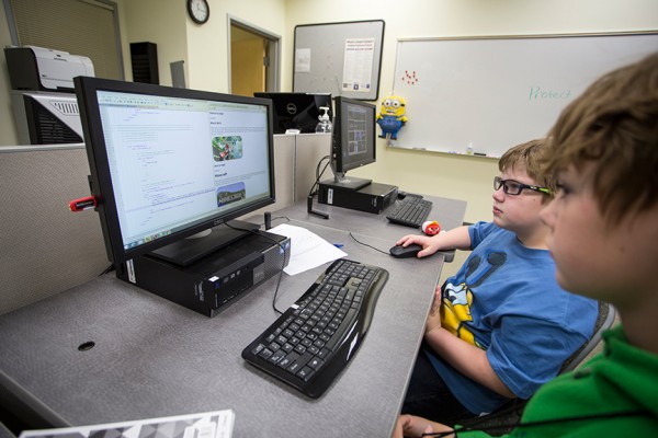 Alex Lehman, left, and Simon Mitchell work on one of their projects during the creative coding class at UAA Continuing Education Kids' College in summer 2015. (Photo by Theodore Kincaid/University of Alaska Anchorage)