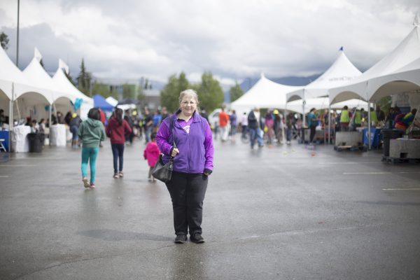 Bonnie Palach, B.Ed. '92, works with students in the Newcomers' Program. She ran into several current and former students at the Mountain View Street Festival and World Refugee Day, pictured (Photo by Ted Kincaid / University of Alaska Anchorage).
