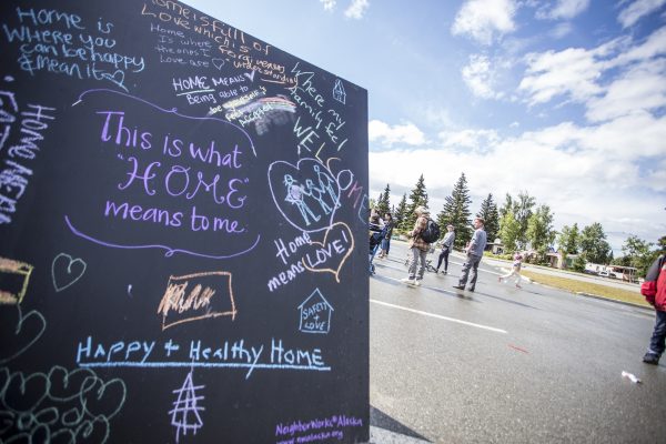 Neighbors write what home means to them at the Mountain View Street Fair. The neighborhood is the nation's most diverse census tract, according to a UAA professor's joint research (Photo by Ted Kincaid / University of Alaska Anchorage).