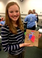 Annika Gagnon, 13, a camper at Mat-Su College's mini med school, displays a clay heart she made. (Photo by Tracy Kalytiak / University of Alaska Anchorage)