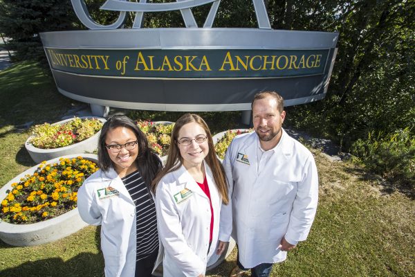 The UAA-Idaho State University partnership creates a home in Anchorage for students hoping to earn a doctor of pharmacy degree. Tiffany Ma and Janelle Solbos are students in the inaugural class, seen here with the program's director, ISU's Tom Wadsworth. (Photo by Theodore Kincaid / University of Alaska Anchorage)