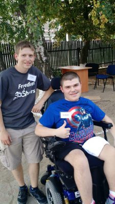 After hearing of Bariste's efforts, Tim Balz, left, founder of Indiana-based Freedom Wheels, donated a refurbished electric wheelchair so Ionut Balutel could return to the classroom. Balz and his father traveled to Hîrtopul-Mare last summer to meet Ionut and install a wheelchair ramp at the school. (photo courtesy of Tim Balz)