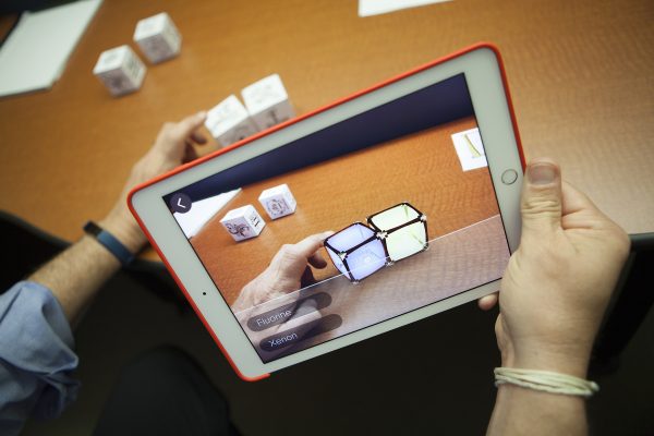  Dave Dannenberg, assistant professor of instructional technology at University of Alaska Anchorage, shows how augmented reality can be used in science education with the chemical bonding app Elements 4D (Photo by Phil Hall / University of Alaska Anchorage).