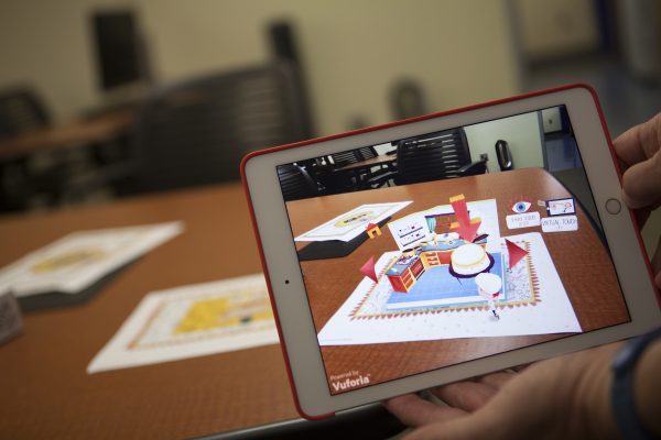 Dave Dannenberg, assistant professor of instructional technology at University of Alaska Anchorage, demonstrates Peronio, a digital children's pop-up book, which uses augmented reality in early childhood education (Photo by Phil Hall / University of Alaska Anchorage).