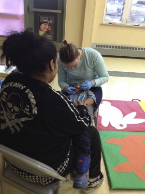 A UAA student examines a child at a rural Head Start. (Photo by Lisa jackson)