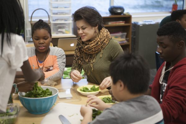  International studies major Anna Ponurkina with students at Mountain View Elementary School. (Photo by Phil Hall / University of Alaska Anchorage).