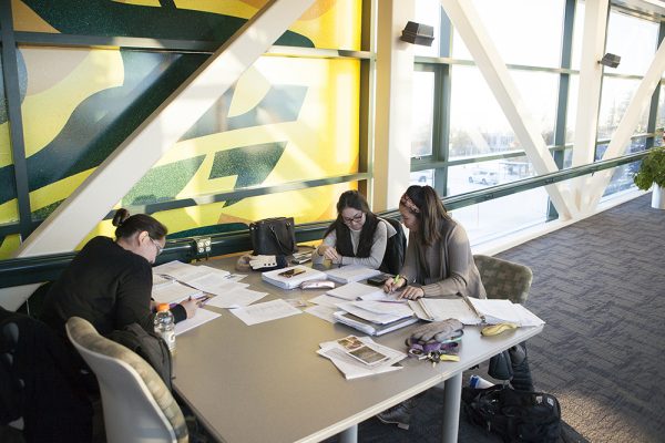 UAA students Janet Carson, Maricris Cayabyab, and Kristin Carroll study in the Spine on Dec. 9. (Photo by Philip Hall / University of Alaska Anchorage)