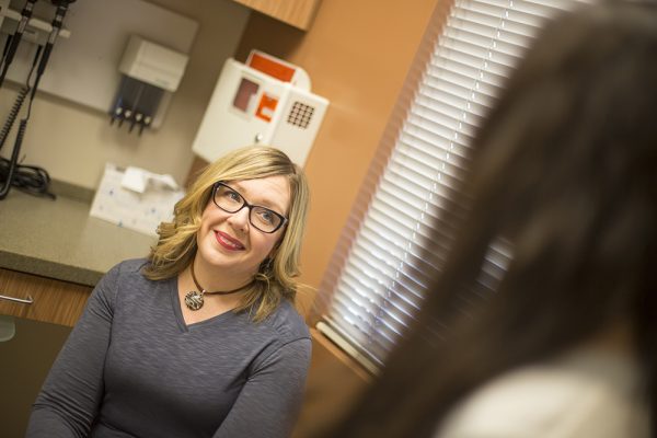 Christa talks with UAA DNP alumna Jyll Green at myHealth Clinic a few minutes before receiving a shot of Vivitrol. Green's DNP project studied the effectiveness of Vivitrol shots among people just freed from incarceration. The shot Christa received Tuesday was her fourth since she left jail. (Photo by Theodore Kincaid / University of Alaska Anchorage)