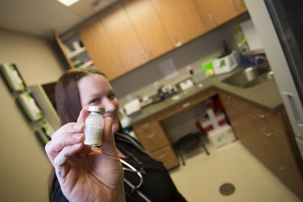 Sandi Johnson, medical assistant at UAA DNP alumna Jyll Green's South Anchorage practice, myHealth Clinic, shows a vial of Vivitrol. Monthly shots of the non-opioid drug prevent opioid addicts from getting high. (Photo by Theodore Kincaid / University of Alaska Anchorage)