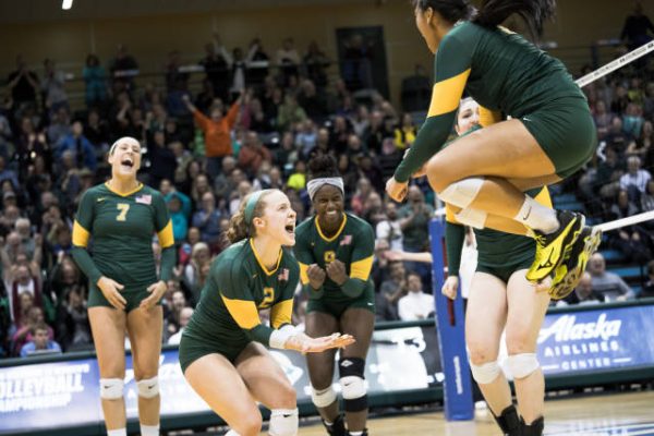 Leah (7) and Chrisalyn (9) react with their teammates during the second round of the NCAA tournament, Dec. 2 (Photo by Adam Phillips / UAA Athletics).