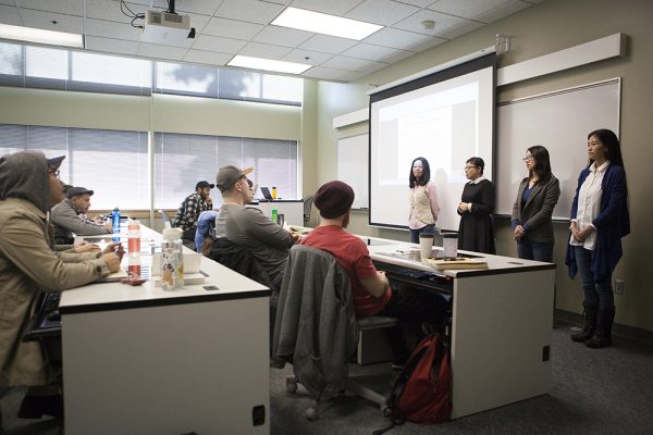 Four professors from Jilin University of Finance and Economics (JUFE) visitors have been in residence at UAA recently. Here, answering questions from students in one of Professor Qiujie "Angie" Zheng's classes, are Yunzhe "Karen" Liu, Xu "Sissi" Dai, Weiyang "Cynthia" Diao, and Jiyu "Tracy" Wang. (Photo by Philip Hall / University of Alaska Anchorage)