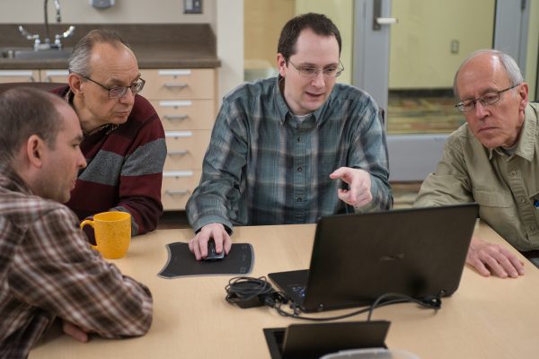 From left to right, Thomas Folan, Gennady Gienko, Kurt Meehleis and Rob Lang discuss their snow load research project. (Photo by James Evans / University of Alaska Anchorage)