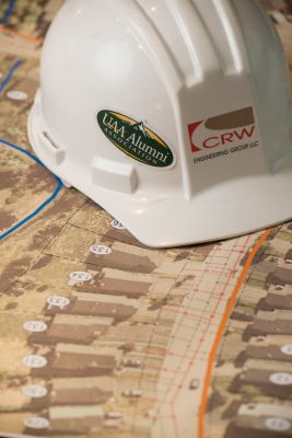 UAA alumni sticker on a CRW hard hat