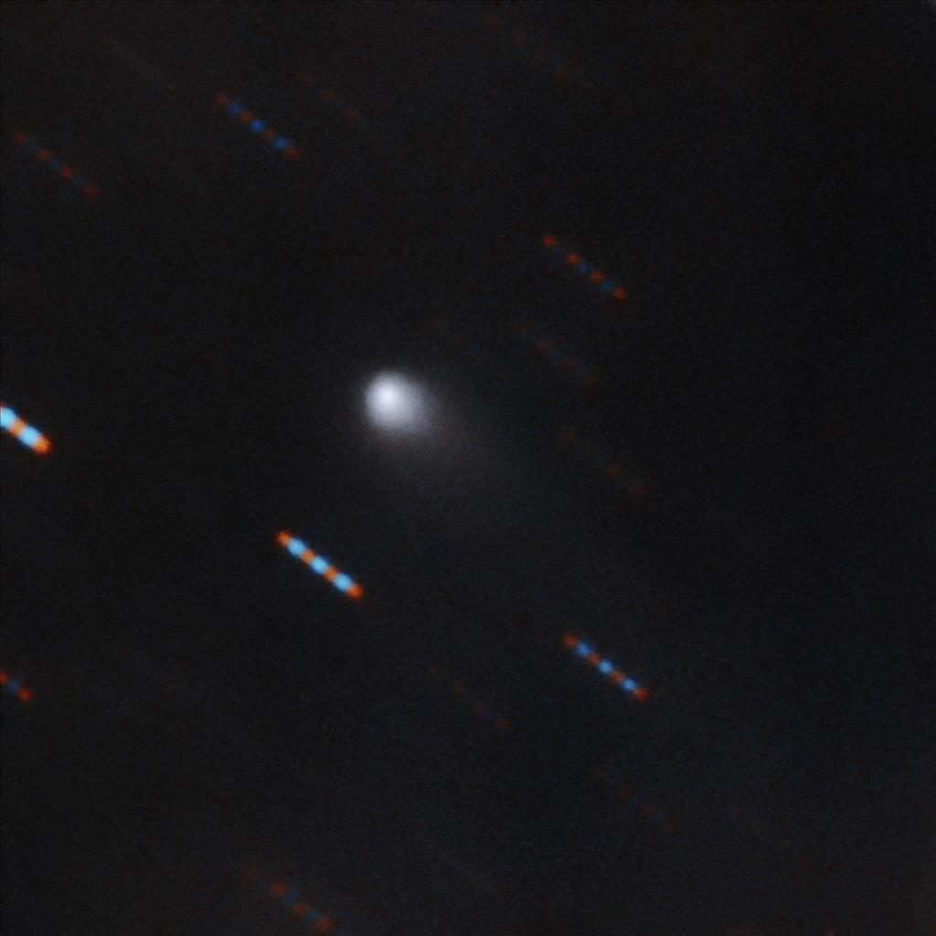 Gemini Observatory two-color composite image of C/2019 Q4 (Borisov) which is the first interstellar comet ever identified. This image was obtained using the Gemini North Multi-Object Spectrograph (GMOS) from Hawaii's Maunakea. The image was obtained with four 60-second exposures in bands (filters) r and g. Blue and red dashes are images of background stars which appear to streak due to the motion of the comet. Composite image by Travis Rector. Image Credit: Gemini Observatory/NSF/AURA 