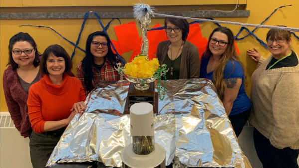 Enrollment Services staff show off their Back to the Future-themed office, decorated for Homecoming 2019.