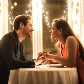 Couple holding hands over a dinner table