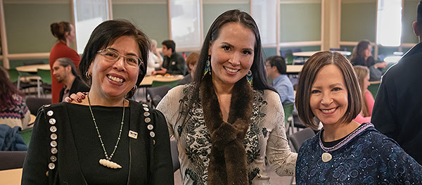 UAA alumna Emily Edenshaw (middle), who was recently named Executive Director of the Alaska Native Heritage Center, takes a photo with Professor of Music and Alaska Native Studies Maria Williams (left) and Chancellor Cathy Sandeen (right) at UAA's 2020 Spring Alaska Native Heritage Celebration in Cuddy Hall.