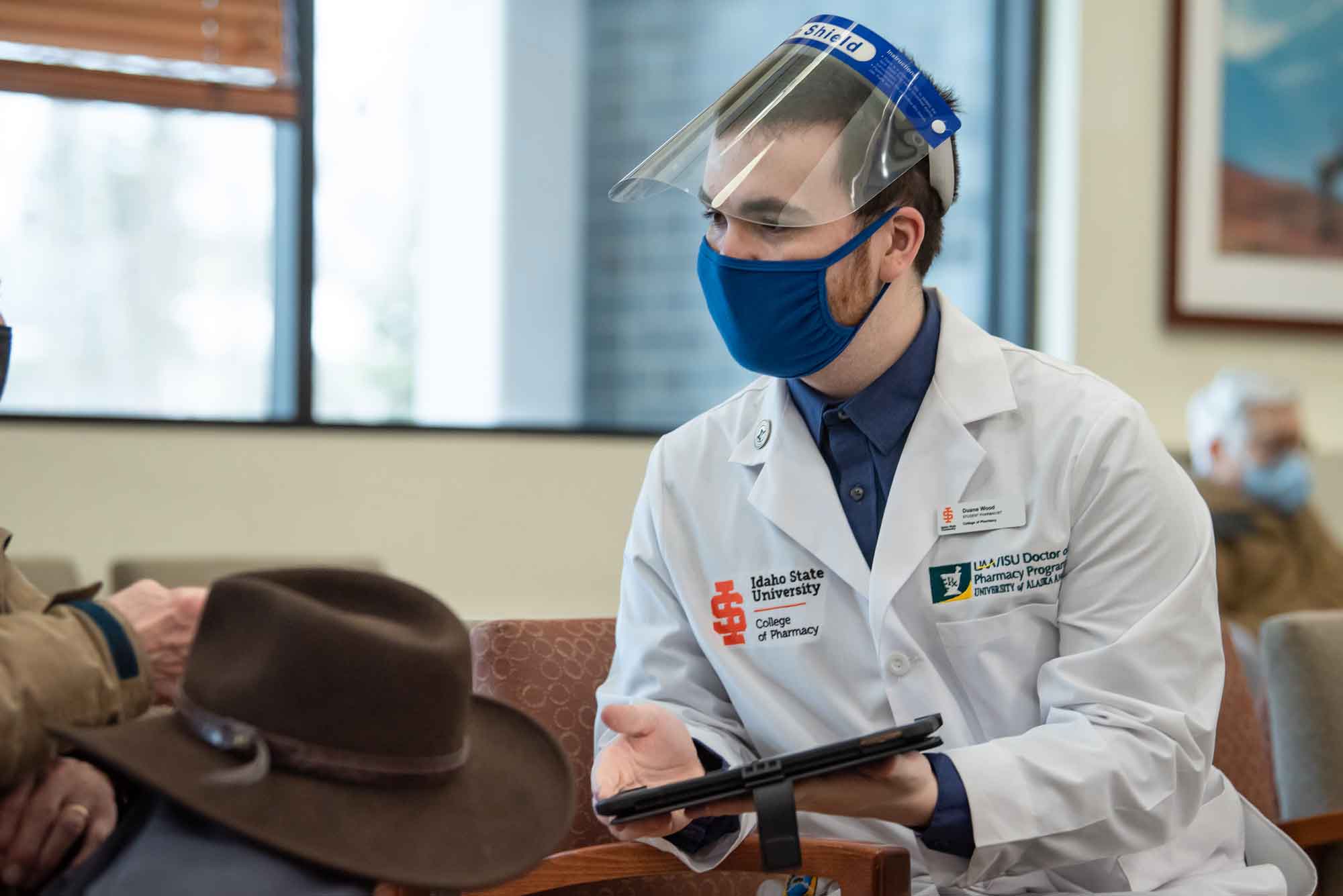 UAA/ISU Doctor of Pharmacy student Duane Wood checks in a vaccine recipient. 
