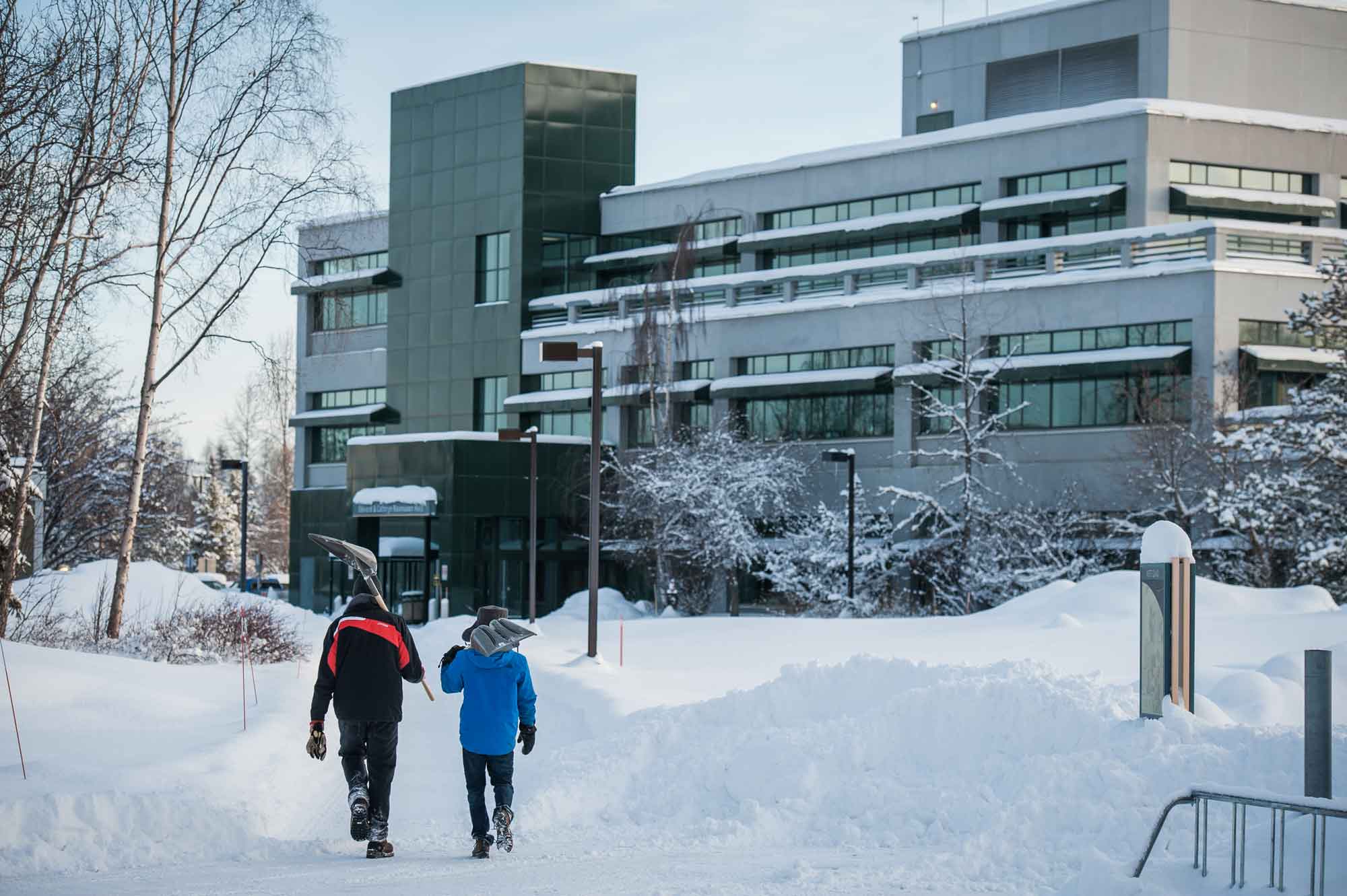 UAA staff help to clear a path through the snow in the Cuddy Quad.